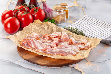 Sliced pork bacon over board