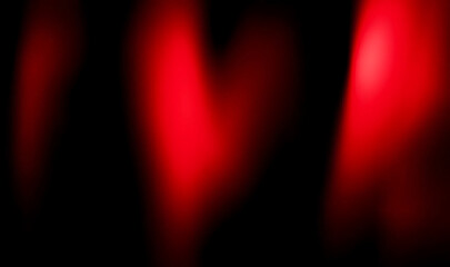 Abstract image showing blurred red light against a dark black background with soft gradients visible
