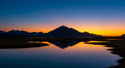 Sunset reflecting on a calm lake.
