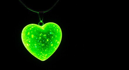 Fototapeta premium Bright green heart pendant glowing in the dark. 