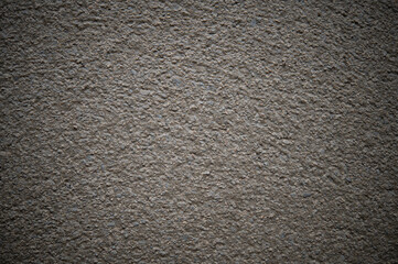 Gray background of concrete floor mixed with small stone chips.