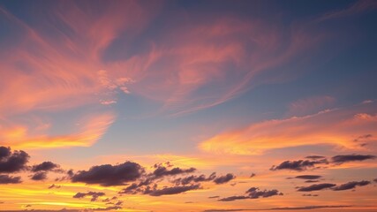 Vibrant sunset sky displays breathtaking orange and pink cloudscape with scattered dark clouds at horizon.