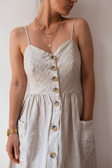 Sophisticated Lady Showcasing Trendy Buttoned Dress and Statement Necklace. Perfect Blend of Modern Style and Elegance