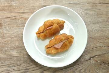 baking crispy butter croissant French bread stuffed ham cheese and spinach on plate