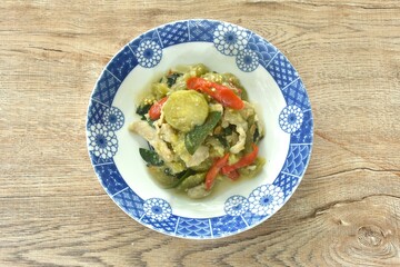 spicy stir fried slice long green eggplant with pork and basil on plate 