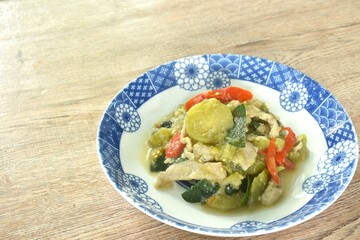 spicy stir fried slice long green eggplant with pork and basil on plate 