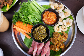 Northern Thai spicy green chilli dip with sausage and crackling with vegetable set on banana leaf is traditional Thai food
