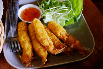 Fresh crispy fried shrimp with vegetable and sauce in white plate