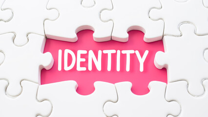 Puzzle Piece with Text Identity on Bright Pink Background for Concept of Individuality