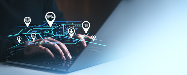 Logistics network digital map with location icons over hands typing on laptop keyboard.