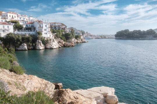 Scenic view of the Skiathos coastline with the old port in the distance.