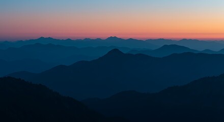 Fototapeta premium Sunset mountain layers with pink and blue hues fading into horizon. Ideal for peaceful backgrounds, travel design, or meditative visuals.