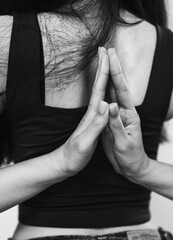 Black-white photo of Back Namaste Pose. Hands in Reverse Prayer Behind the Back &ndash; a symbol of Inner Peace, Strength, and Flexibility in Yoga Practice