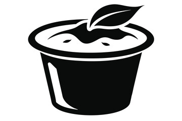 Black cup filled with liquid and a single leaf resting on top is displayed