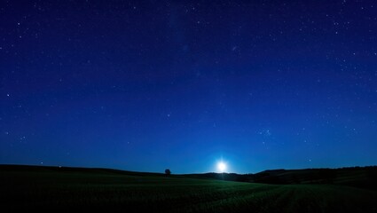 Fototapeta premium Night sky over field at dawn landscape