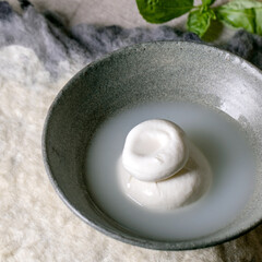 Traditional italian burrata knotted cheese in bowl