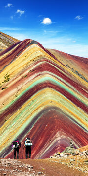 Rainbow mountains with tourists and beautiful clouds