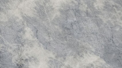 A close-up of a textured gray surface with subtle variations, evoking a sense of depth and natural...