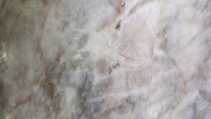 A close-up of a serene onyx stone surface with delicate swirls and subtle metallic flecks that catch the light.