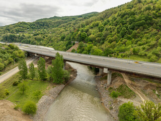 Aerial view of a quiet highway passing through a tunnels in a picturesque hilly region Rikoti Pass