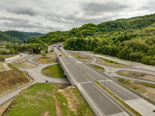 Aerial view of a quiet highway passing through a tunnels in a picturesque hilly region Rikoti Pass