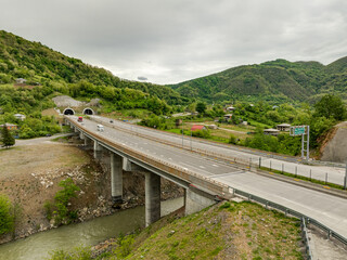 Aerial view of a quiet highway passing through a tunnels in a picturesque hilly region Rikoti Pass