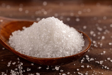 Granulated sugar in a spoon, detail macro photography of the granules