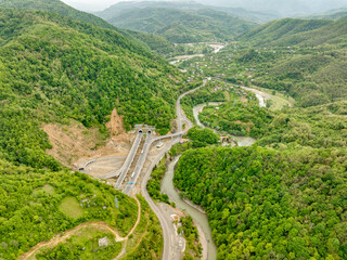 Aerial view of a quiet highway passing through a tunnels in a picturesque hilly region Rikoti Pass