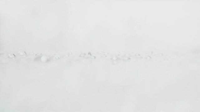 A blurry image of something that looks like a snowdrift or a very light-colored surface with some small, indistinct objects scattered across it.  It is not clear what is shown in the image.