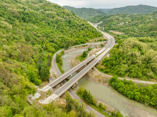 Aerial view of a quiet highway passing through a tunnels in a picturesque hilly region Rikoti Pass