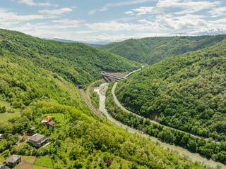 Aerial view of a quiet highway passing through a tunnels in a picturesque hilly region Rikoti Pass