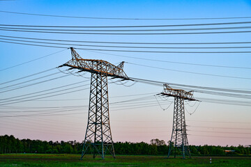 Power poles in spring on the field and meadow, Brandenburg, Germany