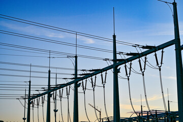 Power poles in spring on the field and meadow, Brandenburg, Germany