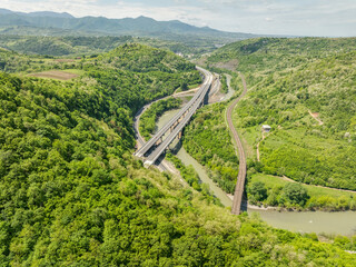 Aerial view of a quiet highway passing through a tunnels in a picturesque hilly region Rikoti Pass