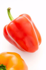 A close-up of a vibrant red bell pepper with a glossy surface and green stem.