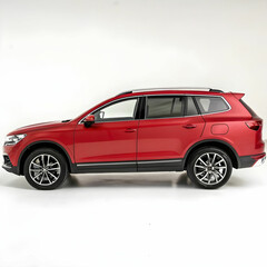 Obraz premium A sleek, generic red SUV in side view, isolated on a white background.