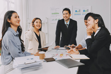 Team of financial advisory services. Asian advisor showing plan of investment to clients in the consultancy office..