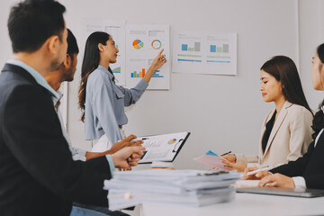 Team of financial advisory services. Asian advisor showing plan of investment to clients in the consultancy office..