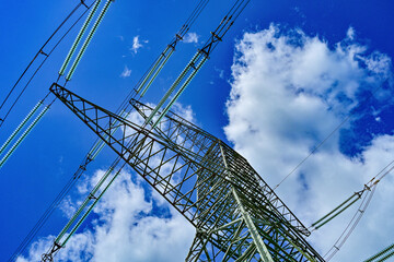 Power poles in spring on the field and meadow, Brandenburg, Germany