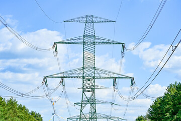 Power poles in spring on the field and meadow, Brandenburg, Germany