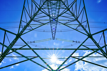 Power poles in spring on the field and meadow, Brandenburg, Germany