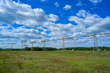 Power poles in spring on the field and meadow, Brandenburg, Germany