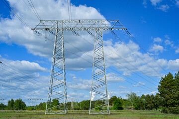 Power poles in spring on the field and meadow, Brandenburg, Germany