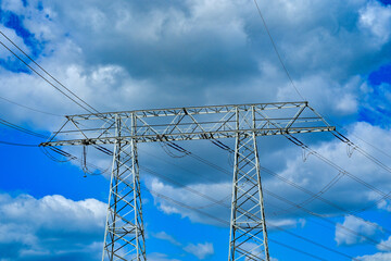 Power poles in spring on the field and meadow, Brandenburg, Germany