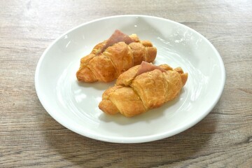 baking crispy butter croissant French bread stuffed ham cheese and spinach on plate