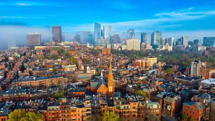 Orange brick houses along stunning skyscrapers. Varied scenery of Boston, Massachusetts, USA. Aerial view.