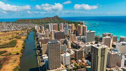 Modern high-rise architecture of Waikiki from aerial view. Diamond Head Crater and azure waterscape...