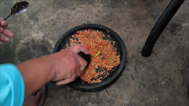 the process of making peanut sauce for traditional Indonesian food called pecel