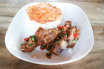 stir fried pork or deep fried pork , fried pork or crispy pork and rice with fried egg or sunny side up egg or pork and rice