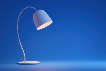 A stylish desk lamp stands on a smooth surface, casting a warm glow. The sleek design features a curved neck and a minimalist shade, creating a calming atmosphere in a blue-toned environment.